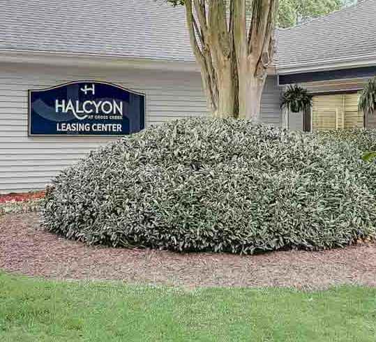 A building with a sign that says Halcyon in front of it.