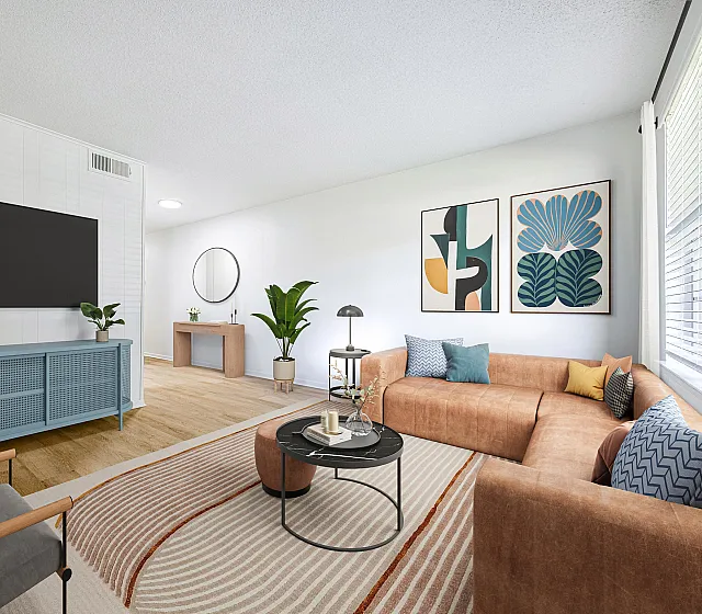 Bright and inviting living room with a plush sectional sofa, modern decor, and natural light streaming through large windows.
