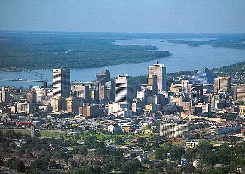 Stunning panoramic view of a vibrant city skyline with modern skyscrapers and a tranquil river backdrop, ideal for urban living enthusiasts.