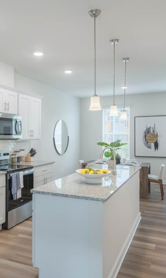 A modern kitchen with stainless steel appliances and a center island.