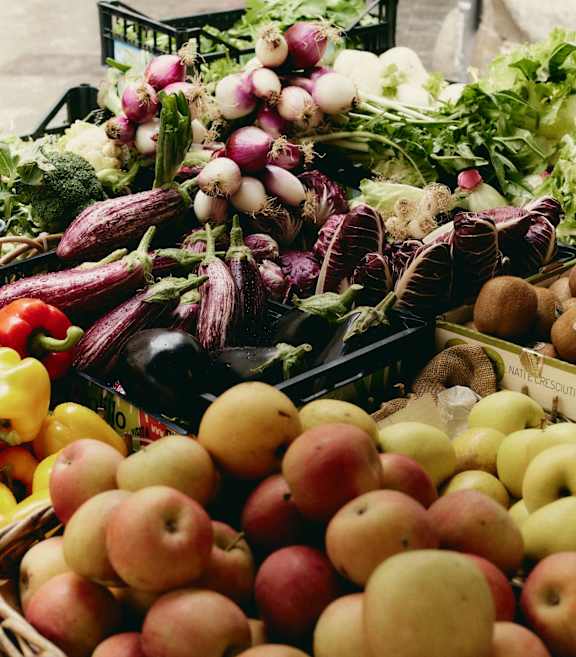 A variety of fruits and vegetables are displayed for sale.