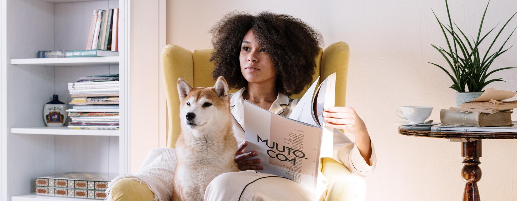 a person sitting on a couch with a dog