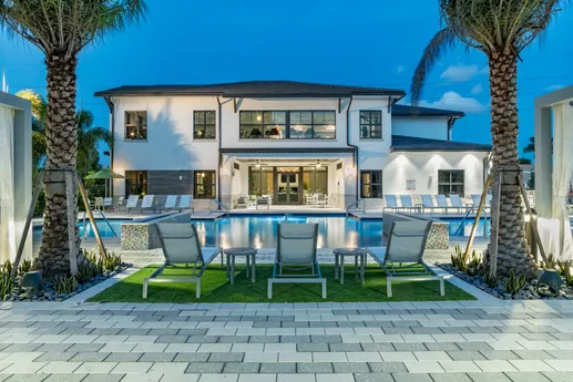Outdoor community pool with lounge chairs.
