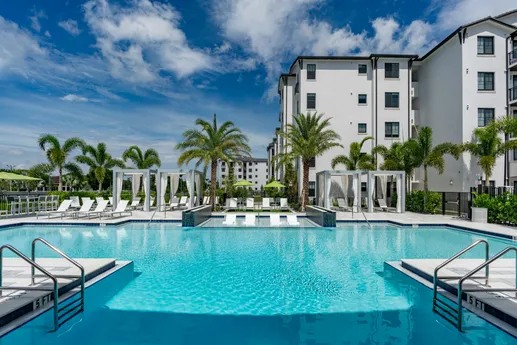 Outdoor community pool with cabanas.