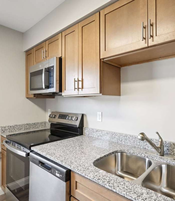 Modern kitchen with steel appliances at Charleston Square Apartments in Columbus, Indiana