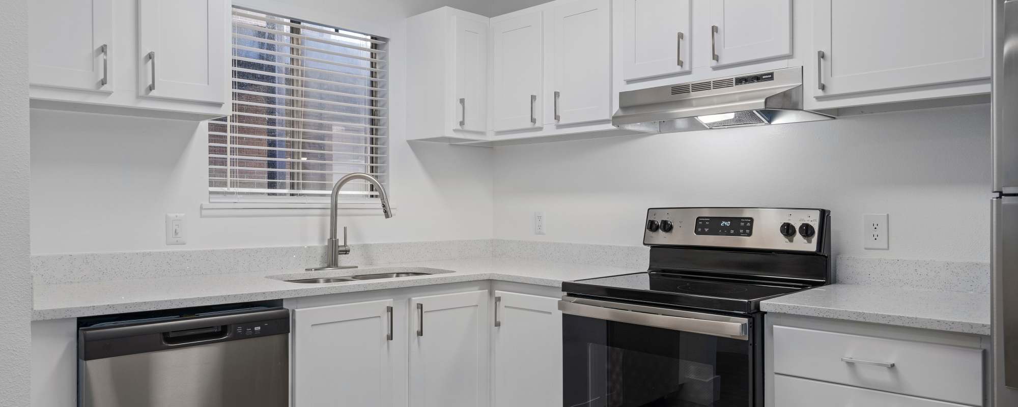 Model kitchen with white accents at The Franklyn Apartments in Millcreek, Utah