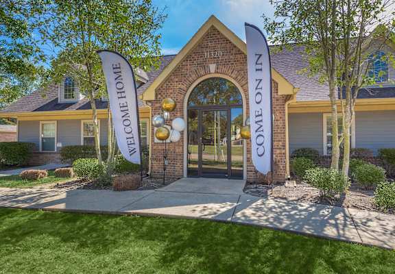 A house with a sign that says "Welcome Home" in front of it.
