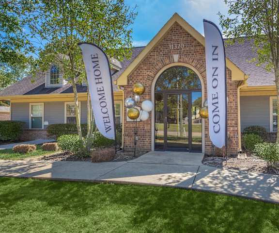 A house with a sign that says "Welcome Home" in front of it.