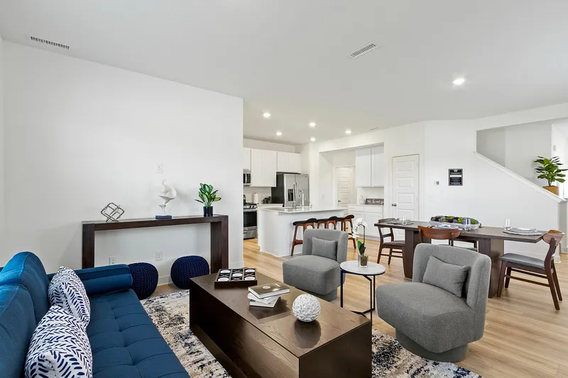Furnished living area overlooking dining and kitchen area