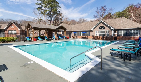 Spacious sparkling pool with sundecks and cabanas for lounging.
