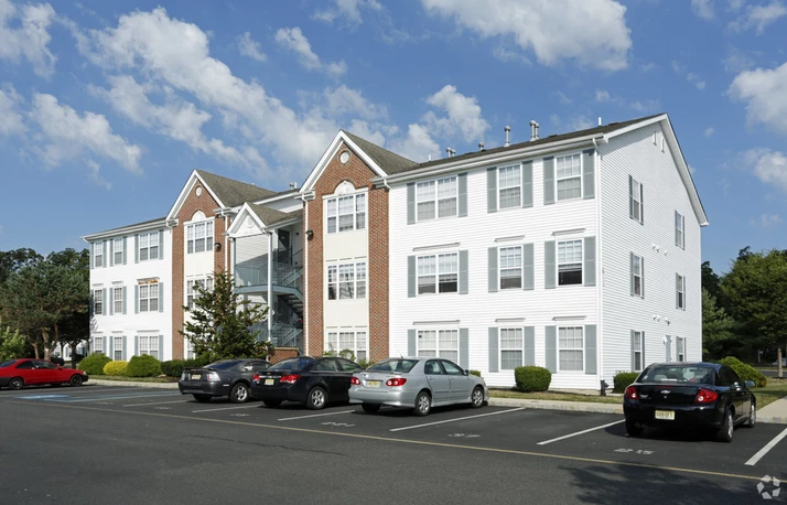 Picture of apartment building and parking lot
