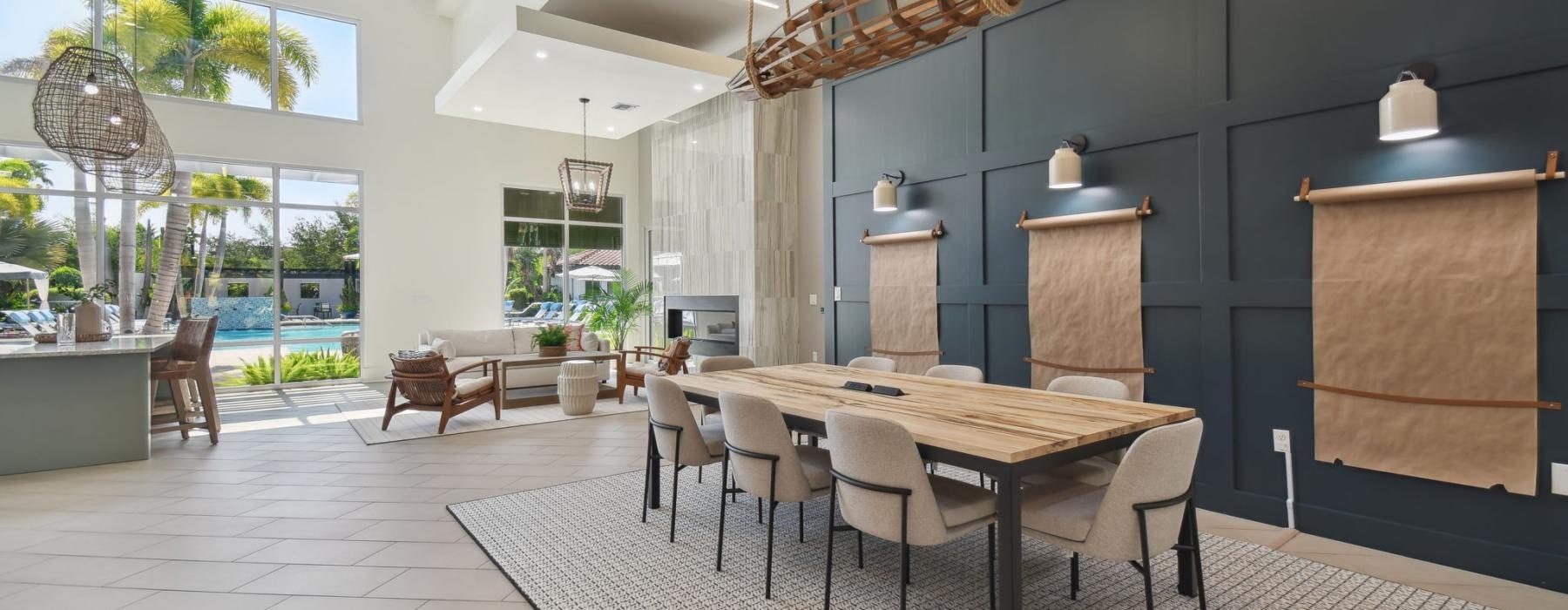 a spacious room with a chandelier and chairs