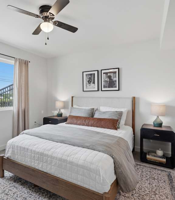 A furnished bedroom with window and natural light