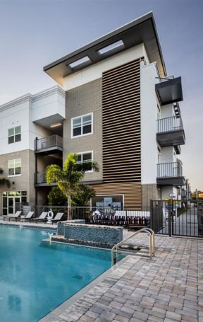 a swimming pool with a building in the background