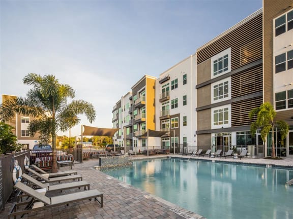 a large swimming pool in front of some apartment buildings