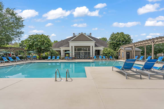 a resort style pool with lounge chairs and a clubhouse in the background at Fortress Grove, Tennessee, 37128