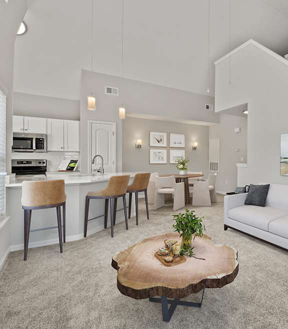 A modern living room with a blue couch and a coffee table. at Fortress Grove Apartments, Murfreesboro, TN, 37128