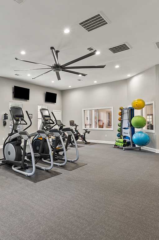 a workout room with treadmills and a tv at Fortress Grove Apartments, Murfreesboro, TN, 37128