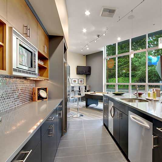 A modern kitchen with a large island and stainless steel appliances.