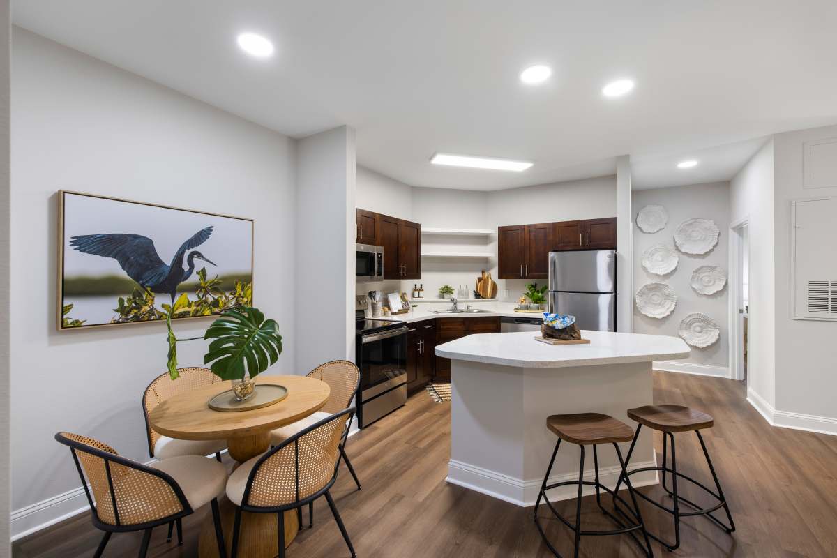 Living room and kitchen in a model home at The Apartments at Shade Tree in Johns Island, South Carolina
