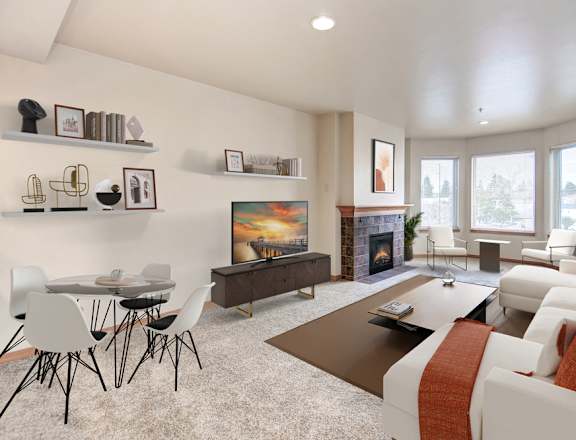 a living room with white couches and chairs and a coffee table in front of a fireplace