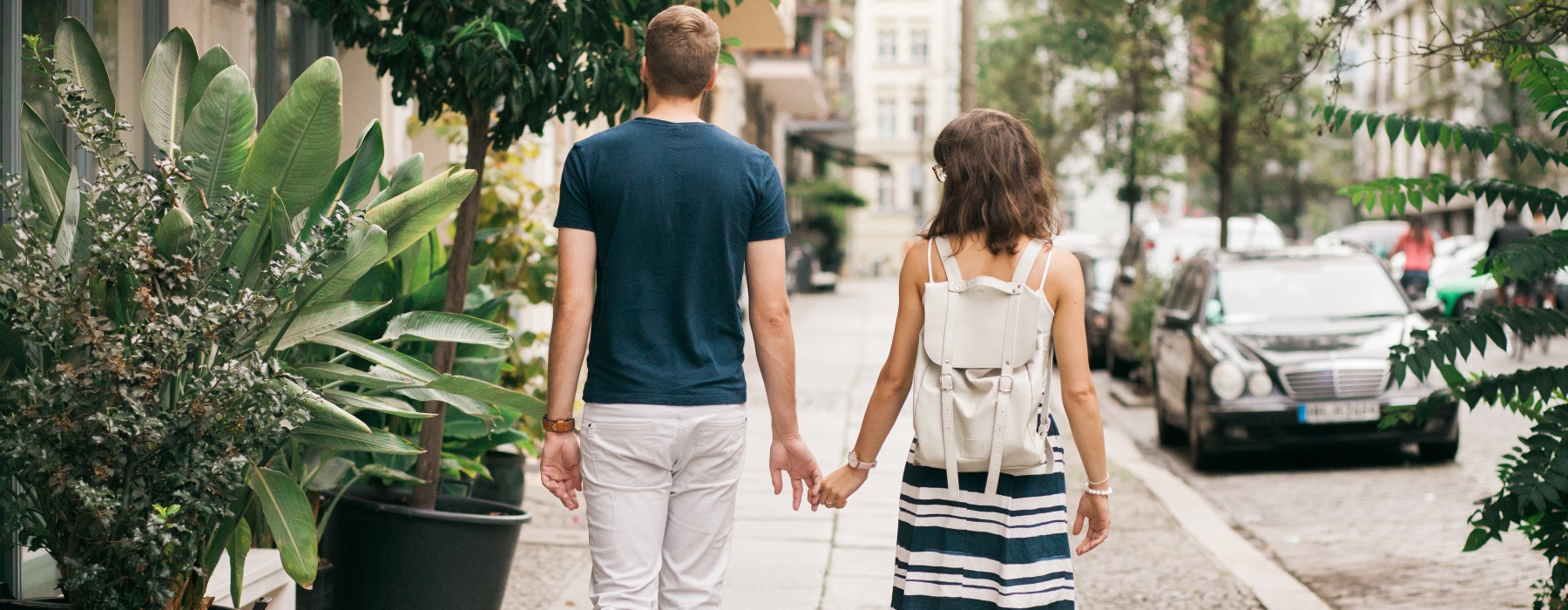 Man and woman walking down a sidewalk