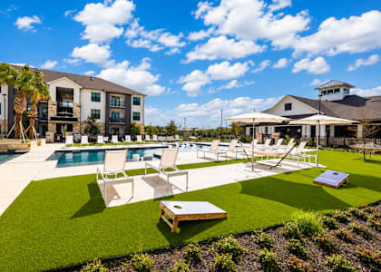 A sunny day at a resort with a pool and lounging area.