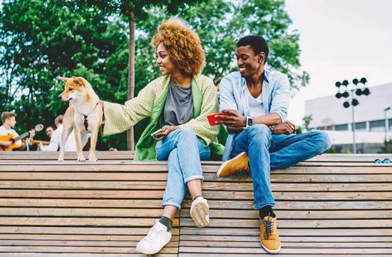 guy and girl outside at a park with dog
