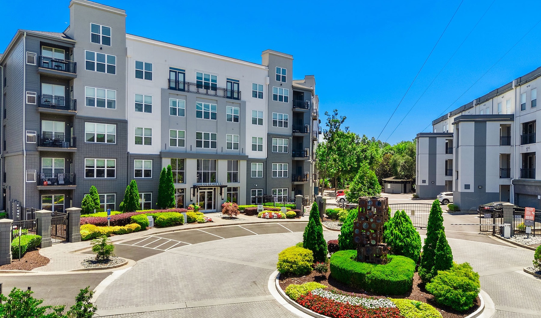 a large building with a garden in a parking lot