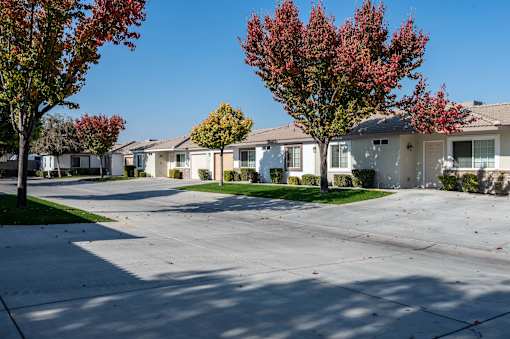 a row of houses on a street with trees