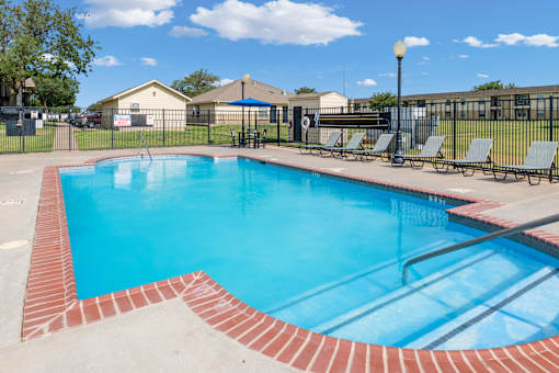 A small pool with a red brick border.