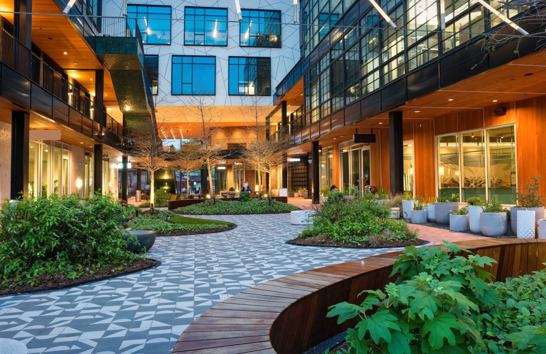 an outdoor courtyard with plants and a walking path