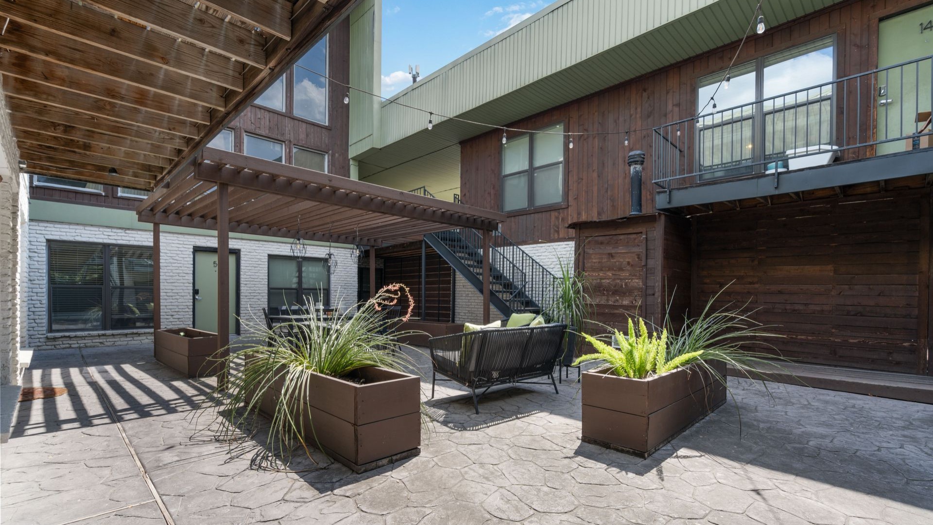 courtyard with planters and a staircase