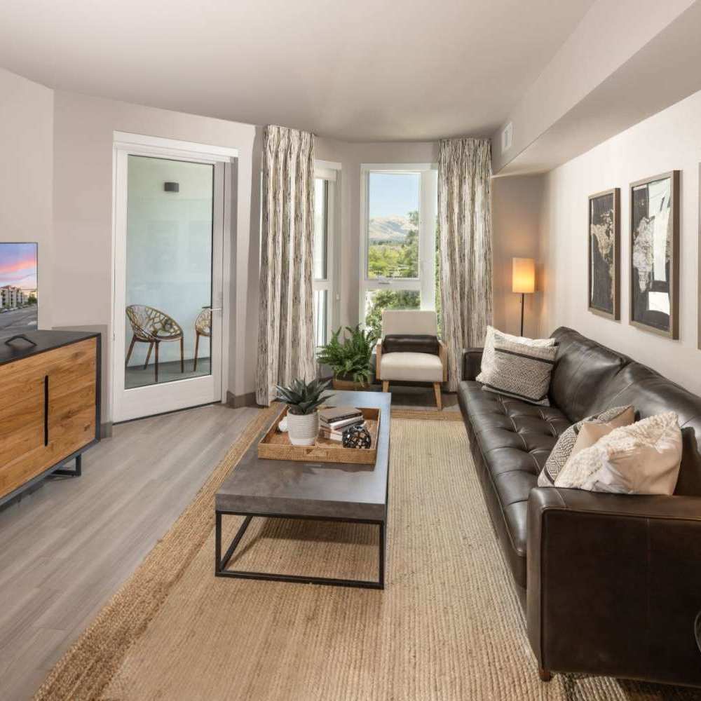 Living room with plank style flooring at The Beacon in Fremont, California