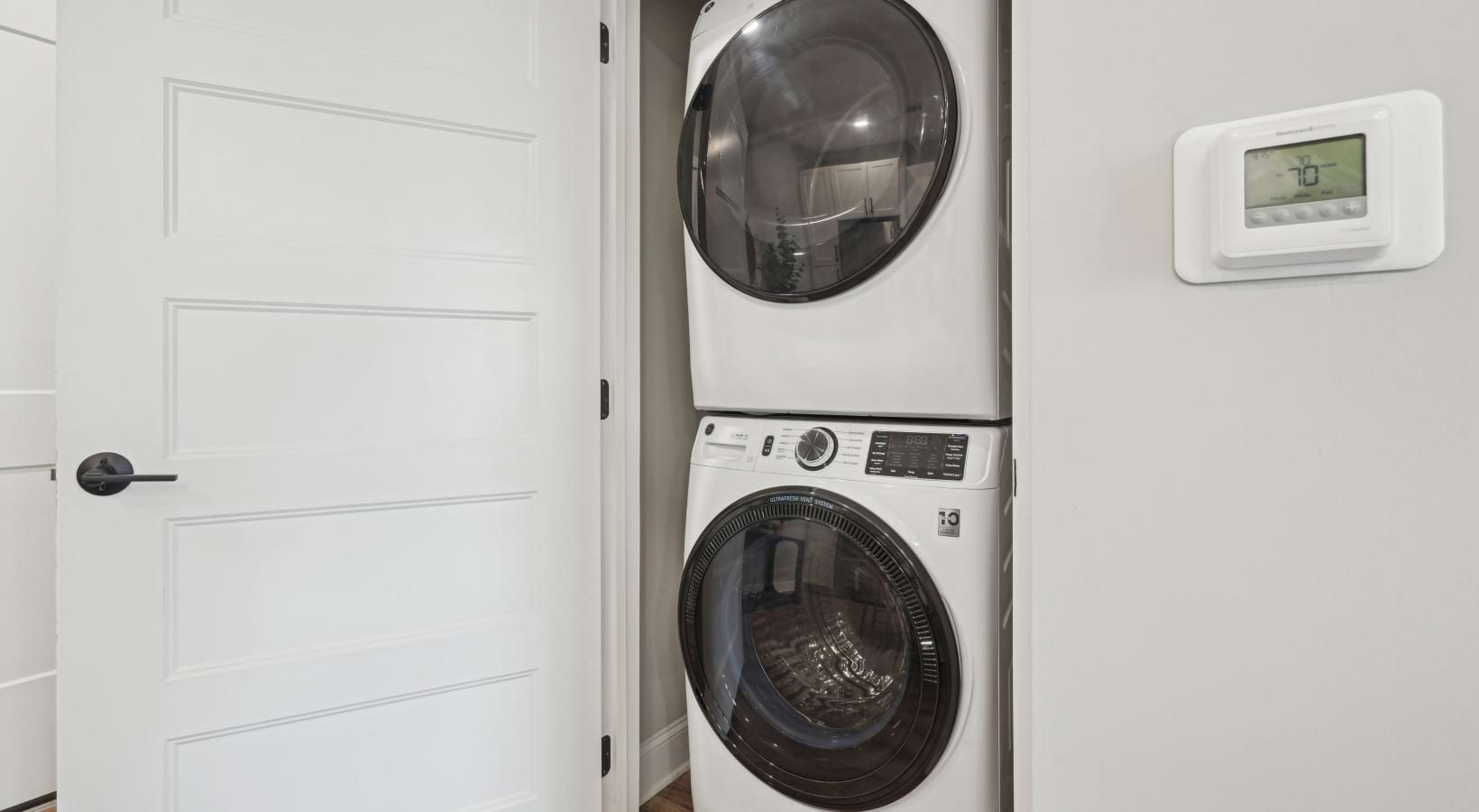 Linen closet with stacked washer and dryer combo