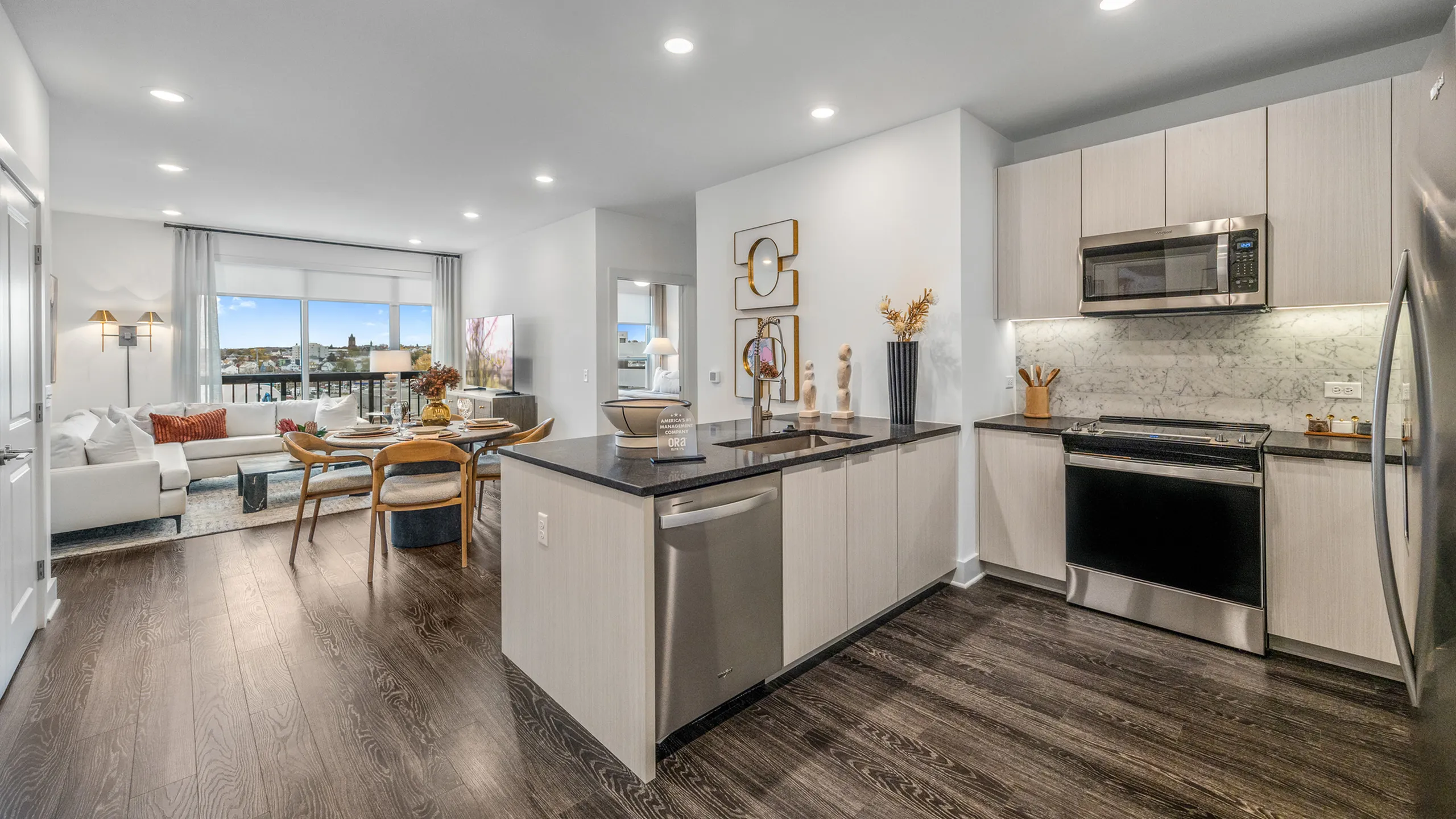 Modern open-concept apartment with a chic kitchen, stylish living area, and large windows offering stunning views.