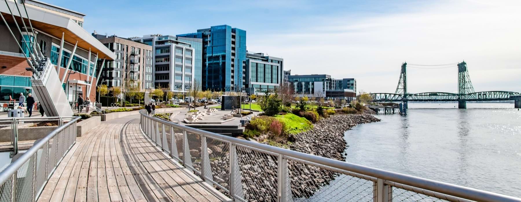 a bridge over a body of water with buildings in the background