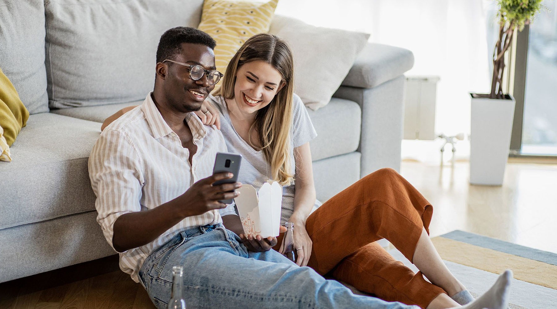a couple laughing looking at a phone