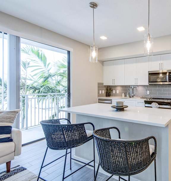 A kitchen with a white countertop and stainless steel appliances at Mayla Pompano Beach, Pompano Beach, FL