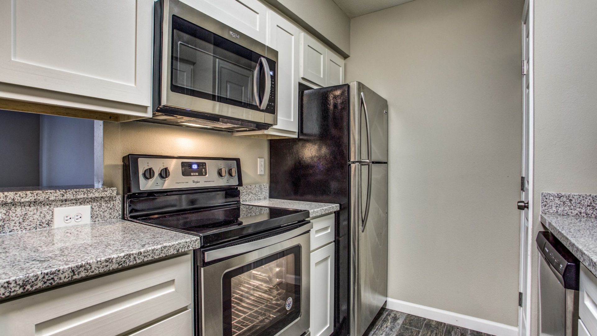 Kitchen with granite countertops and stainless steel appliances at Clear Creek Landing in Houston, TX