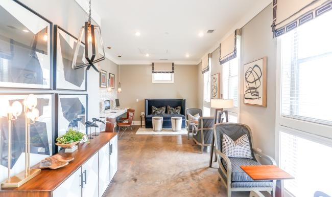 a room with a couch and chairs