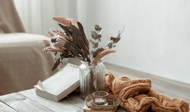 a vase with flowers and a book