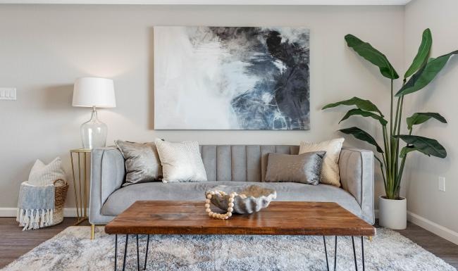 a couch with a coffee table and a painting on the wall