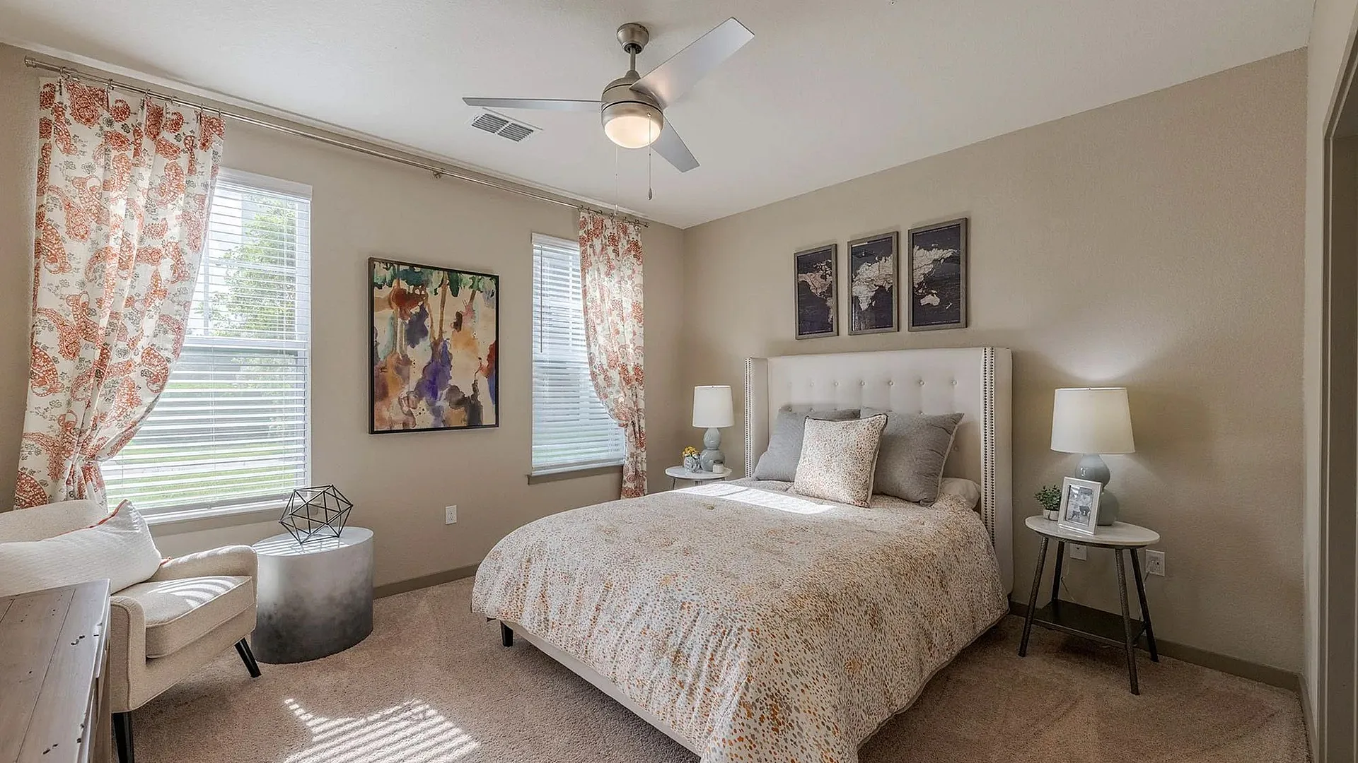 A cozy bedroom with a bed, decorative curtains, and stylish furniture.