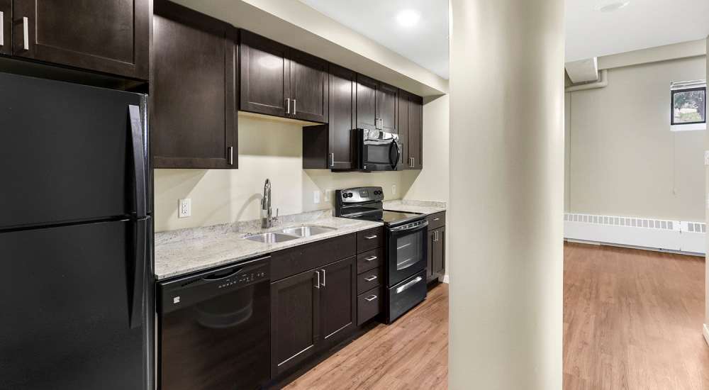 Kitchen with cabinetry and black appliances at 430 Oak Grove in Minneapolis, Minnesota