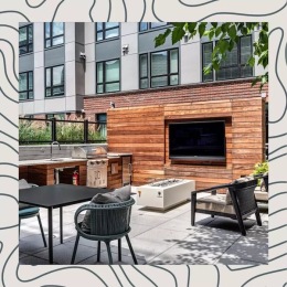 a patio area with a tv, tables and chairs