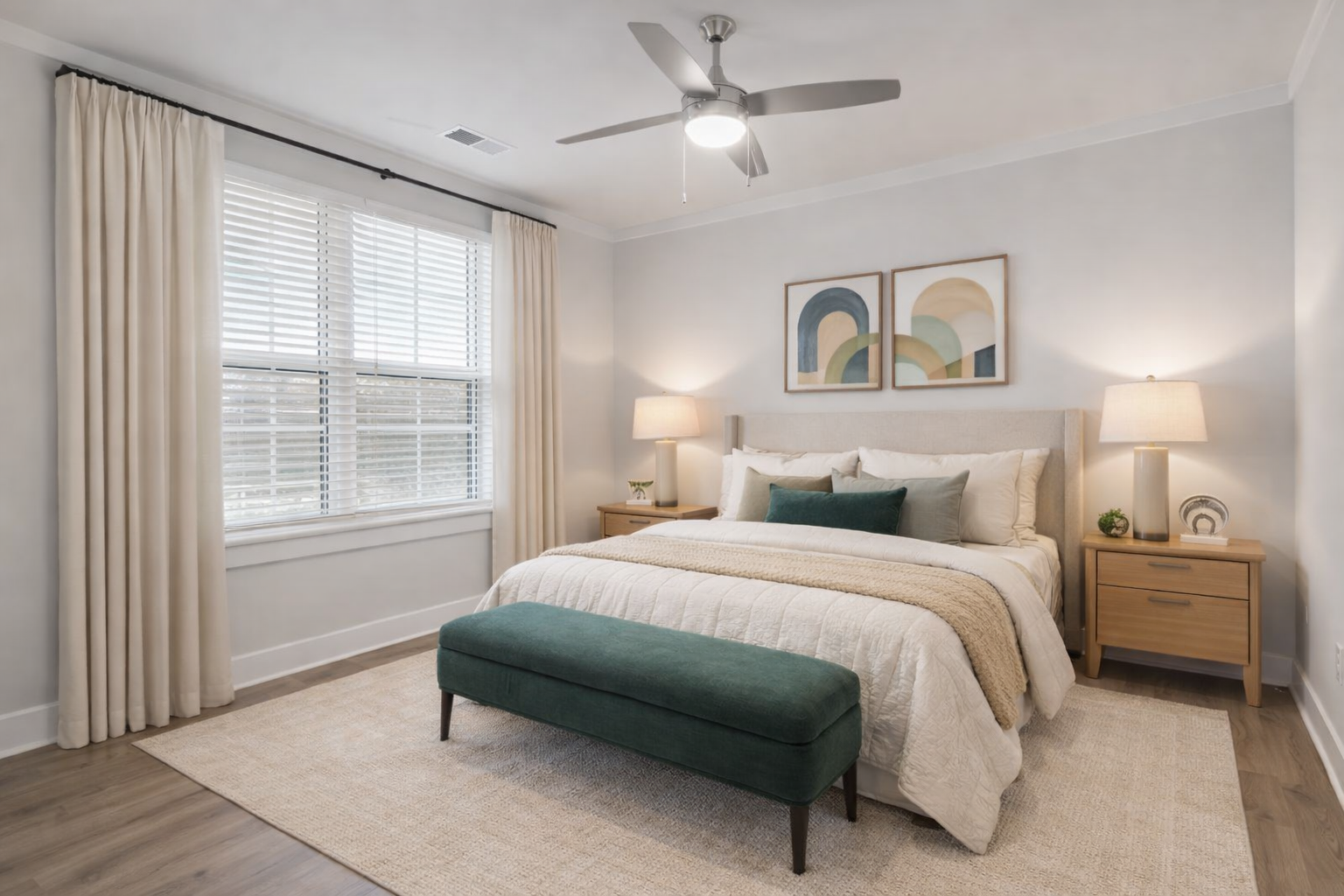 Modern bedroom in a Charlotte apartment with natural light from large windows and a comfortable, contemporary design.