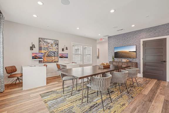 A dining room with a white table and chairs.