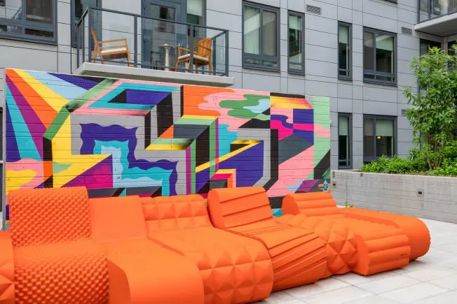 Orange couch in front of courtyard artwork. One of the things to see at The Kelvin in Washington, DC.