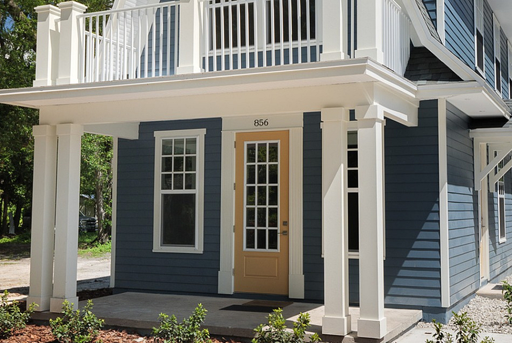 Blue two-story student home with white trim and second-floor balcony at Old Row at Eastwood near UF Gainesville